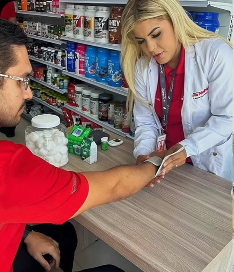 Farmacêutica de jaleco branco atendendo um cliente no balcão da loja
